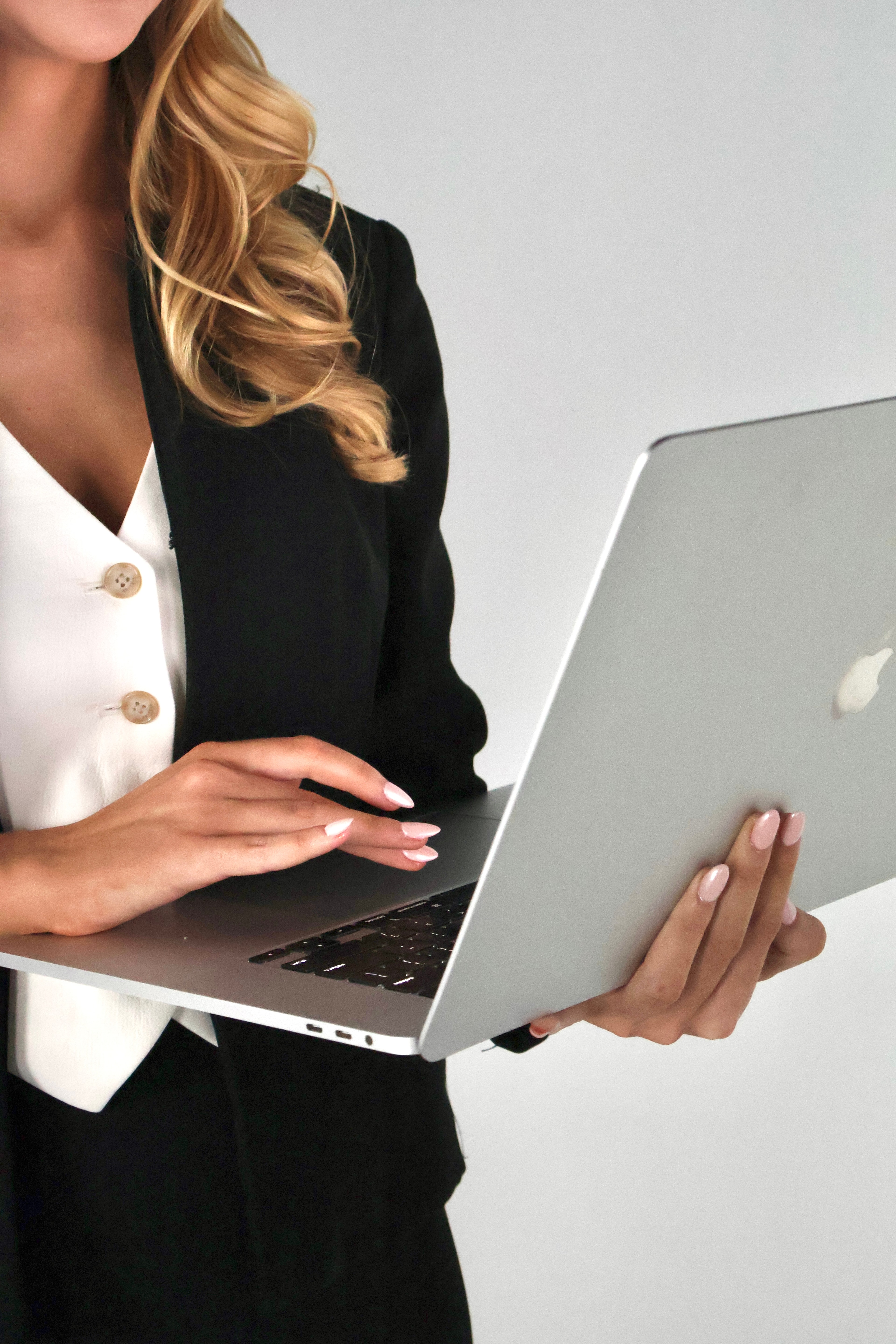 A woman holding an open laptop